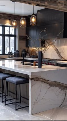 a kitchen with marble counter tops and stools