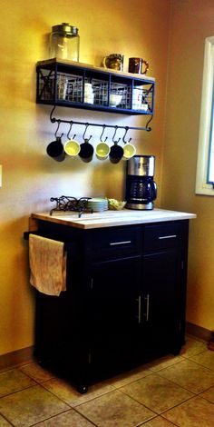 a small kitchen with pots and pans hanging on the wall