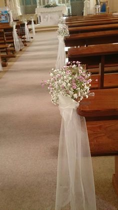 a bouquet of flowers sitting on the pews of a church