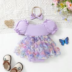 Keep your little one cool and stylish in our LAVENDER Romper Dress with Headband. This adorable outfit features puff sleeves and comes with an included headband for a complete look. Perfect for summer and for your baby girl to rock the cutest fashion. Summer Bubble Romper With Ruffles And Puff Sleeves, Summer Puff Sleeve Bubble Romper With Ruffles, Fitted Puff Sleeve Bubble Romper For Spring, Cute Spring Bubble Romper With Matching Headband, Playful Puff Sleeve Summer Dress, Summer Dress-up Bubble Romper With Ruffles, Short Sleeve Bubble Romper For First Birthday In Summer, Summer Short Sleeve Bubble Romper For First Birthday, Summer Fitted Bubble Romper For Playtime