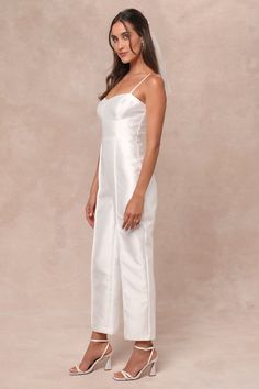 Get ready to become an overnight style icon in the Lulus Contemporary Pose White Taffeta Bustier Sleeveless Jumpsuit! Crisp woven taffeta, with a subtle sheen throughout, shapes adjustable spaghetti straps that support a bustier-style bodice with seamed cups and a high, fitted waist. Straight legs boast seamed detailing as they fall to ankle-length hems. Hidden zipper/clasp at back. Fit: This garment fits true to size. Length: Ankle length. Size medium measures 47.5" from adjustable straps to he Elegant Jumpsuits And Rompers With Spaghetti Straps, Fitted Sleeveless Satin Jumpsuits And Rompers, Fitted Silk Jumpsuits And Rompers For Spring, Spring Silk Fitted Jumpsuits And Rompers, Elegant Fitted Satin Strapless Jumpsuit, Chic Satin Strapless Jumpsuit, Fitted Satin Jumpsuits And Rompers For Spring, Spring Satin Fitted Jumpsuits And Rompers, Fitted Silk Jumpsuits And Rompers For Summer