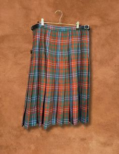 Preloved and Preworn This vintage traditional kilted skirt is custom-made from lightweight 10 oz tartan fabric, featuring 3/4 inch pleating at the back for that classic kilt swing. With two buckled straps on one side and one on the inside, this gorgeous piece is a classic design never goes out of style! 100% Pure New Wool Made at the Lochcarron mill in the heart of the Scotland. Artwork by artist Christopher Porter Waist 32-34” Hips 42” Length 27” If you are expecting a “new” perfect piece, thes Scotland Artwork, Vintage Traditional, Tartan Fabric, Curated Vintage, Upcycled Vintage, Kilt, Vintage Gifts, Out Of Style, Classic Design