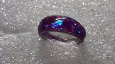 a purple ring sitting on top of snow covered ground