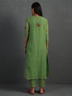 A straight-cut kurta in cotton silk fabric with all-over floral buttis made using A straight-cut kurta in cotton silk fabric with all-over floral buttis made using beads, sequins and silk French knots. Kurta, pants and dupatta have a lace edging at the hem, side cut, and sleeve ends. Bead work runs along the neckline and in between lace patterns. Delicate pin tucks stitched across the organza dupatta with embroidered scalloped edges and machine stitches in between pin tucks. Elasticated waist co Spring Anarkali Slub Silk Kurta, Slub Silk Straight Kurta With Embroidered Border, Slub Silk Set With Floral Embroidery And Straight Kurta, Spring Green Salwar Kameez With Embroidered Border, Embroidered Cotton Silk Kurta For Summer, Summer Embroidered Cotton Silk Kurta, Cotton Silk Straight Kurta With Embroidered Border, Spring Cotton Silk Kurta With Zari Work, Green Embroidered Cotton Silk Kurta