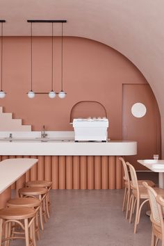 the interior of a restaurant with tables, chairs and stools in front of it