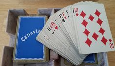 several playing cards in a box on a table