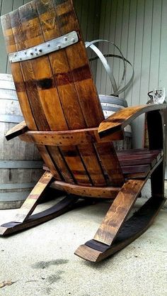 a wooden rocking chair made out of wine barrels