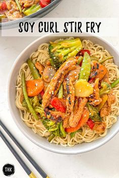 two bowls filled with stir fry chicken and veggies