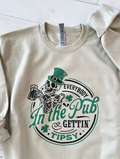 Funny St Patricks day sweatshirt, St Pattys day parade top, Everybody in the Pub Gettin Tipsy shirt, Irish crew gift, Irish drinking sweater ▬▬▬▬▬▬▬▬▬▬▬▬▬▬▬▬ DETAILS ▬▬▬▬▬▬▬▬▬▬▬▬▬▬▬▬ Our sweatshirts are SUPER soft and SUPER comfy. They do RUN BIG! Make sure to choose your size accordingly! ▬▬▬▬▬▬▬▬▬▬▬▬▬▬▬▬ FABRICATION ▬▬▬▬▬▬▬▬▬▬▬▬▬▬▬▬ 8 oz., 50% Cotton/ 50% Polyester -- Preshrunk -- Double needle stitching at shoulder, armhole, neck, waistband and cuffs ▬▬▬▬▬▬▬▬▬▬▬▬▬▬▬▬ MATERIALS ▬▬▬▬▬▬▬▬▬▬▬▬▬▬▬▬ Direct to garment printer (ink) ▬▬▬▬▬▬▬▬▬▬▬▬▬▬▬▬ CARE INSTRUCTIONS ▬▬▬▬▬▬▬▬▬▬▬▬▬▬▬▬ Machine wash Do not iron directly on letters ▬▬▬▬▬▬▬▬▬▬▬▬▬▬▬▬ PERSONALIZATION ▬▬▬▬▬▬▬▬▬▬▬▬▬▬▬▬ We absolutely love customizing orders for people! The best feeling is being able to add a personal touch to our designs Sweater Details, Funny St Patricks Day, Best Feeling, The Pub, Christmas Catalogs, St Pattys, St Pattys Day, Direct To Garment Printer, Printer Ink