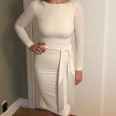 This Beautiful, Off-White Sheath Dress Is In Near Perfect Condition, And Was Only Worn Once On Wedding Day. Dress Has A Scoop Back And Sleeves Down To Wrist. Dress Hem Hits Just Above The Knee And Is 100% Polyester Size Medium. Has A Lot Of Stretch And Zipper Up The Back But Sits Very Fitted On Body. Pictures Make It Look Pure White, But It Is Off-White. Dress Has Been Dry Cleaned And Left In Dry Cleaning Bag, No Stains. - Hidden Back-Zip Closure - Bateau Neck - Long Sleeves - Attached Sash - Scoop Back - Back Slit - Lined 90% Polyester, 10% Spandex Specifications - Hidden Back-Zip Closure - Bateau Neck - Long Sleeves - Attached Sash - Scoop Back - Back Slit - Lined Pit To Pit Approx 17 White Long Sleeve Bodycon Dress For Formal Occasions, White Long Sleeve Bodycon Dress For Formal Events, White Long Sleeve Bodycon Dress For Work, White Belted Midi Dress For Evening, Chic Fitted White Belted Dress, Elegant White Belted Dress For Formal Occasions, Chic White Fitted Belted Dress, Fitted Belted Dress For Brunch, White Belted Midi Dress For Party