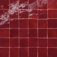 a red tiled wall with water running down it