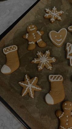 several decorated cookies are on a baking sheet