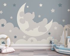 a child's room decorated in blue and white with mickey mouse on the moon