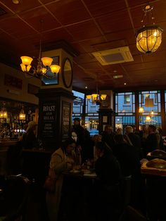 people sitting at tables in a dimly lit restaurant