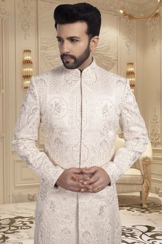 Introducing U2-S341, the ultimate choice for the discerning groom. This unique sherwani is designed to make a statement on your special day. With its luxurious fabric and exquisite craftsmanship, you'll feel like a true king on your wedding day. Complete your look with U2-S341. Luxury Transitional Sherwani With Sequins, Fitted Bandhgala With Chikankari Embroidery For Wedding, Designer Long Sleeve Sherwani For Groom, Designer Dabka Sherwani For Reception, Fitted Sherwani With Chikankari Embroidery For Groom, Wedding Set With Naqshi Details, Fitted, Wedding Fitted Set With Naqshi, Wedding Set With Naqshi, Fitted, Fitted Traditional Wear With Naqshi For Groom