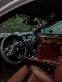 the interior of a car with flowers on the dashboard