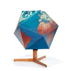 an upside down blue and red umbrella on top of a wooden stand with the world in it's center