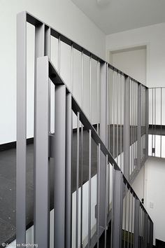 an empty room with white walls and metal railings