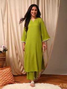 This green Kurta with Trousers set is made from a luxurious silk blend fabric, creating a stylish and comfortable outfit. The Kurta features a straight shape and round neck with flared three-quarter sleeves, while the Trousers have a partially elasticated waistband and slip-on closure for ease of wear. With a calf leng Festive Green Long Sleeve Pant Set, Elegant Summer Sets With 3/4 Sleeve, Green Straight Kurta Pant Set For Spring, Summer Viscose Workwear Sets, Summer Workwear Sets In Viscose, Summer Workwear Viscose Sets, Spring Workwear Long Sleeve Palazzo Set, Elegant Green Pant Set For Eid, Summer Sets With 3/4 Sleeve