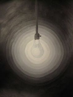 a light bulb hanging from the ceiling in a dark room