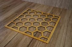 a wooden floor mat with honeycombs on it in the shape of a hexagonal grid