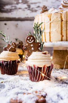 some cupcakes with frosting and decorations on them are sitting in the snow