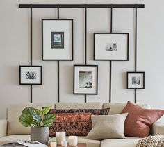 a living room filled with lots of furniture and pictures on the wall above it's coffee table