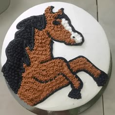 a cake decorated with an orange and black horse