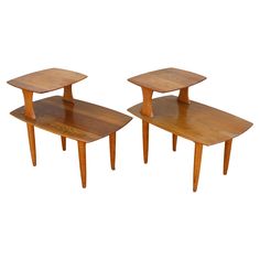 two wooden tables sitting next to each other