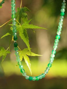 This elegant necklace features a stunning combination of small silver beads and gradient green jadeite to create a captivating multi-element design. Each bead is carefully strung together to create a harmonious composition, and the gradient green jade adds a touch of energy and elegance to the necklace, while the various elements create visual interest and depth. Metal: Recycled Sterling Silver Plated On Brass Gemstone: Green Strawberry Quartz 7mm,Green Chalcedony 7.5mm Length: 390mm Weight: 29g Green Strawberry, Element Design, Green Chalcedony, Gemstone Beaded Necklace, Elegant Necklace, Strawberry Quartz, Fresh Green, Elegant Necklaces, Green Jade