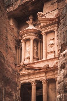 an ancient building carved into the side of a cliff