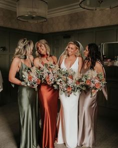 the bridesmaids are holding their bouquets and smiling at each other in this photo