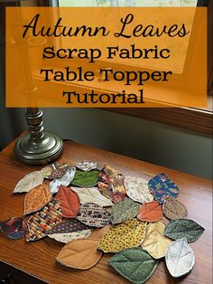 an autumn leaves scrap fabric table topper sitting on a desk next to a window