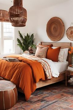 a bedroom with orange bedding and hanging wicker baskets on the wall above it