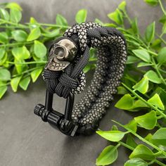 Each paracord bracelet features a black metal shackle and stainless steel black coated skull bead. All of our paracord is US manufactured, military grade, ensuring it is of the highest quality. please note that the finish on the matte black shackle will tarnish over time. For sizing, please measure your wrist with a tape measure, do not allow any slacks or gaps in the tape and select this for the size. For other customised orders please do get in touch. Black Outdoor Bracelet Jewelry, Black Bracelet Jewelry For Outdoor, Adjustable Black Braided Bracelet, Adjustable Black Paracord Jewelry, Durable Black Paracord Bracelets, Adjustable Black Braided Bracelet For Outdoor, Adjustable Black Paracord Braided Bracelet, Adjustable Black Bracelets For Outdoor, Casual Black Paracord Bracelet