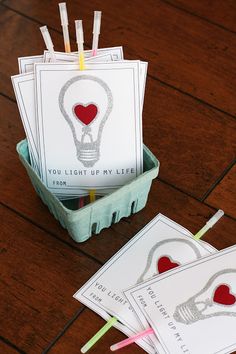 some cards are sitting in a box on the table and one has a light bulb drawn on it