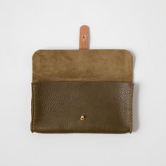 The clutch wallet is a beautiful leather clutch that's handmade from start to finish. Card slots divide the interior, which has plenty of space for your cash, cards, phone, and keys. It's stitched by hand and can be embossed with your initials at no additional charge. It measures 8.5 inches by 4.5 inches, with a 1-inch gusset. Everyday Rectangular Clutch With Card Slots, Rectangular Clutch With Card Slots For Daily Use, Everyday Clutch Wallet With Leather Lining, Everyday Leather Lined Clutch Wallet, Leather Clutch With Card Slots, Leather Envelope Coin Purse For Everyday, Everyday Rectangular Clutch With Coin Pocket, Leather Wallet In Rectangular Case For Everyday Use, Leather Clutch Wallet With Interior Card Slots