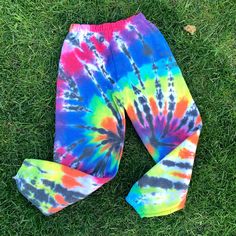 a tie - dyed leggings laying on the grass