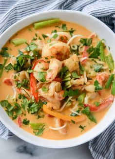 a white bowl filled with shrimp and veggies