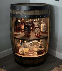 a wooden barrel filled with lots of different types of liquors on top of it