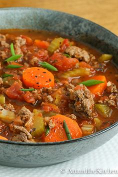 a bowl filled with meat and vegetables on top of a table