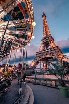 the eiffel tower is lit up at night with lights on it's sides