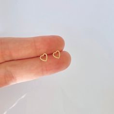 "These perfectly-sized beaded heart studs are simple and dainty. Perfect for layering with other delicate earrings in a first or second hole piercing. * D E T A I L S * ∙ Sold individually (1 stud) or as a pair (2 studs) ∙ Material: .925 Sterling Silver or 18K Gold Plated over .925 Sterling Silver ∙ Dimensions: 6mm ∙ Hypoallergenic & nickel-free * P A C K A G I N G * ∙ All jewelry is sent out beautifully packaged in our signature box & ready for gifting. ∙ In order to reduce waste, we of Earrings Cute Simple, Heart Earrings Gold, Tiny Minimalist Open Heart Jewelry, Minimalist Heart Jewelry For Pierced Ears, Minimalist Double Heart Pierced Jewelry, Minimalist Hypoallergenic Heart Earrings For Valentine's Day, Minimalist Double Heart Earrings, Dainty Pierced Earrings For Valentine's Day, Hypoallergenic Minimalist Heart Earrings For Valentine's Day