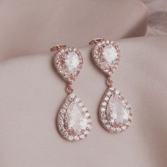 "* Rose Gold Crystal Post Earrings * * Rose gold (rhodium plated over brass) with cubic zirconia crystal teardrop finished with a rose gold ear post. The cubic zirconia teardrop is absolutely stunning. This pair of earrings measure 1 1/4\". * TAKE 10% OFF $75 OR MORE WITH COUPON CODE ~ WEDDINGS10 * TAKE 15% OFF $100 OR MORE WITH COUPON CODE ~ WEDDINGS15 * This pair of earrings will arrive in a box tied with a ribbon perfect for gift giving. Also, included will be a polish pad, anti-tarnish bag w Rose Gold Cubic Zirconia Bridal Earrings For Formal Occasions, Rose Gold Pear-shaped Earrings For Formal Occasions, Pear-shaped Rose Gold Earrings For Formal Occasions, Formal Rose Gold Pear-shaped Earrings, Formal Pear-shaped Rose Gold Earrings, Rose Gold Cubic Zirconia Bridal Earrings For Formal Events, Formal Rose Gold Bridal Earrings With Cubic Zirconia, Rose Gold Bridal Earrings With Sparkling Cubic Zirconia, Rose Gold Cubic Zirconia Bridal Earrings For Anniversary