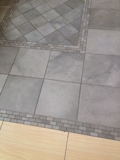 a bathroom floor that has some tile on it