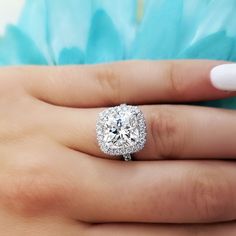 a woman's hand with a diamond ring on it