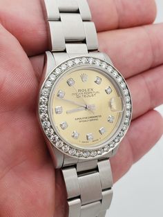 Women's Midsize Rolex DateJust 31mm Stainless Steel Watch with Champagne Diamond Dial and Diamond Bezel. Pre-Owned SN# Y52**** Brand: Rolex. Bezel: Diamond. Gender: Women's. Dial: Diamond Dial. Condition: Excellent. Dial Color: Champagne. Movement: Self-Winding. Case Dimensions: 31mm. Metal Type: Stainless Steel. Bracelet / Strap: Stainless Steel. Box / Certificate: Rolex Box / Certificate of Authenticity. Service Warranty: One (1) Year Limited Service Warranty. Anniversary Diamond Watch With Date Indicator, Anniversary White Gold Diamond Watch With Date Display, Diamond Watch With Date Display For Gift, Anniversary Diamond Watch With Chronometer, Corum Watches, Chopard Watch, Zenith Watches, Rolex Watches Women, Hublot Watches