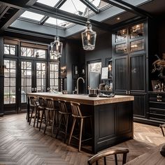 a kitchen with black walls and wooden floors