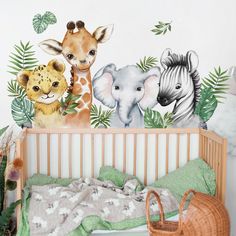 a baby crib with jungle animals on the wall