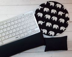 a keyboard and mouse pad with an elephant print